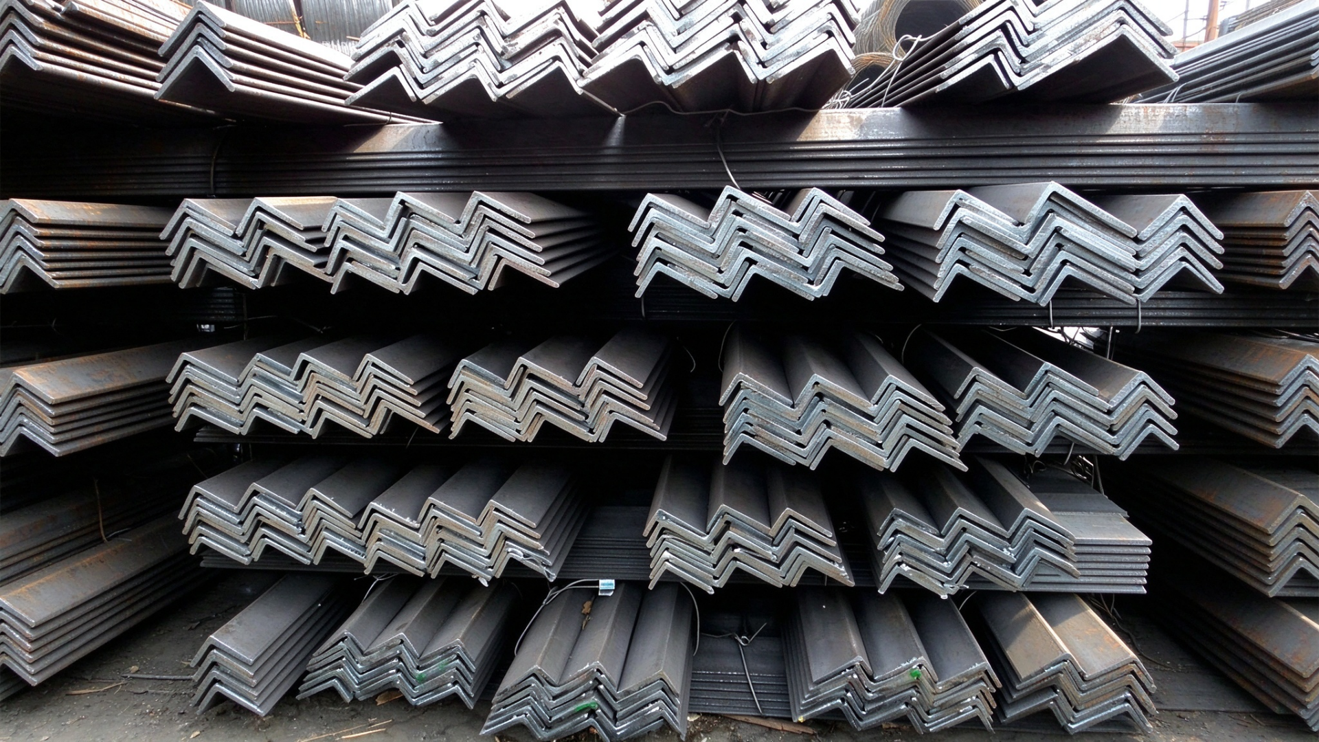 Neatly Bundled 63x40x6mm Unequal Angle Steel Bars Stored in Mill Warehouse