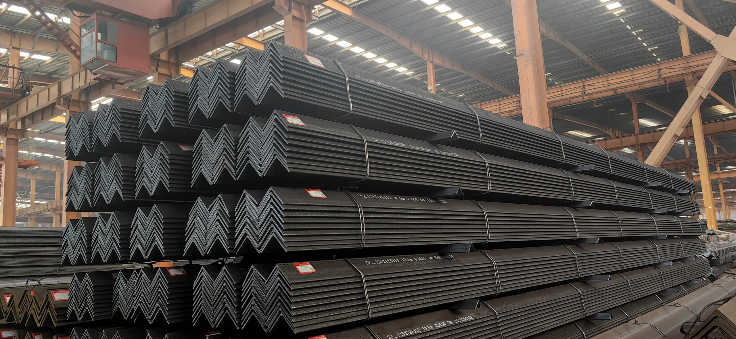 Neatly Stacked and Strapped 40x40x3mm Equal Angle Steel Bundles in Mill Stockyard